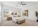 Bright main bedroom featuring neutral tones, plush carpet, and a ceiling fan for added comfort at 35402 N 32Nd Dr, Phoenix, AZ 85086