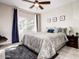 Comfortable bedroom featuring a ceiling fan, neutral tones, and a large window for natural light at 3830 E Lakewood E Pkwy # 3014, Phoenix, AZ 85048