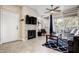 Inviting living room with stacked stone fireplace, modern fan, and sliding doors to the patio at 3830 E Lakewood E Pkwy # 3014, Phoenix, AZ 85048