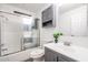 Clean bathroom featuring a shower-tub combination, white walls, and gray cabinets at 4065 E University Dr # 436, Mesa, AZ 85205
