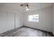Cozy bedroom featuring white walls, wood-look floors, a ceiling fan, and a closet at 4065 E University Dr # 436, Mesa, AZ 85205