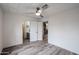 Bright bedroom with wood-look floors, a ceiling fan, and a view to the bathroom at 4065 E University Dr # 436, Mesa, AZ 85205