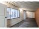 Hallway leading to kitchen, featuring a brick accent wall at 4065 E University Dr # 436, Mesa, AZ 85205