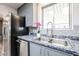 Modern kitchen with granite countertops, stainless steel appliances, and gray cabinets at 4065 E University Dr # 436, Mesa, AZ 85205
