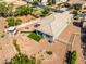 Aerial view of backyard with desert landscaping, fire pit, outdoor kitchen, and artificial grass at 41793 W Canasta Ln, Maricopa, AZ 85138