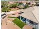 Aerial view of the backyard featuring a built in BBQ area, artificial turf, and cozy seating area at 41793 W Canasta Ln, Maricopa, AZ 85138