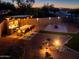 Aerial view of the backyard featuring an outdoor kitchen, seating, and manicured landscaping at 41793 W Canasta Ln, Maricopa, AZ 85138