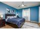 Blue bedroom with a large bed, decorative lighting and patterned area rug at 41793 W Canasta Ln, Maricopa, AZ 85138