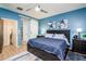 A blue bedroom, featuring a sliding barn door and ensuite bathroom at 41793 W Canasta Ln, Maricopa, AZ 85138