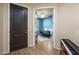 Chic entryway with dark front door, wood floors, and bright blue room with piano visible at 41793 W Canasta Ln, Maricopa, AZ 85138