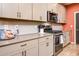 Kitchen features stainless steel appliances, tile backsplash, and plenty of counter space at 41793 W Canasta Ln, Maricopa, AZ 85138