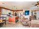 Open-concept kitchen flows into a living room and features a center island with barstool seating at 41793 W Canasta Ln, Maricopa, AZ 85138