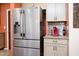 A stainless steel refrigerator and a beverage station with a modern red coffee maker at 41793 W Canasta Ln, Maricopa, AZ 85138
