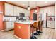This kitchen features an island with seating, stainless steel appliances, and pendant lighting at 41793 W Canasta Ln, Maricopa, AZ 85138