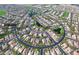 An aerial view shows a Primary-planned community with beautiful homes surrounding a lake with mature landscaping at 4350 S White Dr, Chandler, AZ 85249