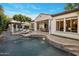 A tranquil backyard featuring a sparkling pool, lounge chairs, dining area, and outdoor living spaces at 4350 S White Dr, Chandler, AZ 85249