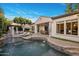 An inviting backyard with a pool, pergola, outdoor seating, dining area, and lush landscaping at 4350 S White Dr, Chandler, AZ 85249
