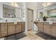 Bright bathroom featuring dual sinks, marble counters, and modern fixtures at 4350 S White Dr, Chandler, AZ 85249