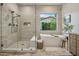 Spa-like bathroom with a soaking tub, a glass-enclosed shower, and neutral tones at 4350 S White Dr, Chandler, AZ 85249