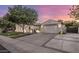 Home featuring a three-car garage, a paved driveway and walkway, and professional landscaping at 4350 S White Dr, Chandler, AZ 85249