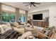 Bright and airy living room with large windows, a comfortable sofa, and custom built-in cabinets at 4350 S White Dr, Chandler, AZ 85249