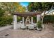 Cozy outdoor kitchen with a built-in grill, fireplace, comfortable seating, and elegant pergola at 4350 S White Dr, Chandler, AZ 85249