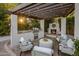 Inviting outdoor kitchen area featuring a fireplace, built-in grill, comfortable seating, and a stylish pergola at 4350 S White Dr, Chandler, AZ 85249