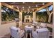 Outdoor kitchen featuring a grill, fireplace, and comfortable seating under a pergola with string lights at 4350 S White Dr, Chandler, AZ 85249