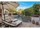 Resort-style pool area featuring a large umbrella, lounge chairs, cascading waterfalls, and lush greenery at 4350 S White Dr, Chandler, AZ 85249