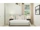 Inviting bedroom with a decorative headboard, patterned wallpaper, and a large window at 4999 S 233Rd Dr, Buckeye, AZ 85326