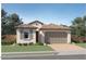 Beautiful single-story home with a tile roof, manicured lawn, and a two-car garage at 4999 S 233Rd Dr, Buckeye, AZ 85326
