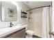 Bathroom boasts a new vanity, framed mirror, open shelving, and shower-over-tub at 5350 S River Dr, Tempe, AZ 85283