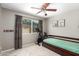 Bedroom featuring natural light, ceiling fan, and space for exercise equipment at 5350 S River Dr, Tempe, AZ 85283