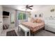 Comfortable bedroom with patterned bedding, neutral walls, and a large window for natural light at 5350 S River Dr, Tempe, AZ 85283