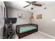Bedroom featuring natural light, ceiling fan, and space for exercise equipment at 5350 S River Dr, Tempe, AZ 85283