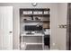 Organized closet with workspace featuring storage shelves and dual monitors at 5350 S River Dr, Tempe, AZ 85283