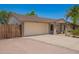 Charming single-story home with a two-car garage, desert landscaping, and a freshly painted exterior at 5350 S River Dr, Tempe, AZ 85283