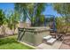 Inviting backyard featuring a modern hot tub, trampoline, and comfortable seating area on the lush lawn at 5350 S River Dr, Tempe, AZ 85283