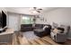 Well-lit living room featuring a comfortable sectional sofa, wood flooring, and a bright window at 5350 S River Dr, Tempe, AZ 85283
