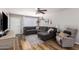 A cozy living room with hardwood floors, a gray sofa, stylish decor, and ample natural light at 5350 S River Dr, Tempe, AZ 85283