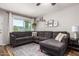 Cozy living area with a gray sectional sofa, a patterned rug, and a well-lit ambiance at 5350 S River Dr, Tempe, AZ 85283