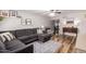 Open-concept living room boasts hardwood floors, a plush gray sofa, and a decorative gallery wall at 5350 S River Dr, Tempe, AZ 85283