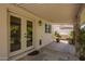 Relaxing covered patio is great for entertaining, featuring neutral pavers, decor, and outdoor access at 5350 S River Dr, Tempe, AZ 85283