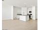 Bright open-concept kitchen featuring white cabinets, an island, and modern stainless steel appliances at 653 W Freedom St, Florence, AZ 85132