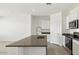 Bright kitchen with white cabinets, stainless steel appliances, and granite countertops at 653 W Freedom St, Florence, AZ 85132