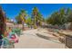 Spacious backyard featuring mature landscaping, concrete pool, and a tall fence providing privacy at 7259 E Glencove St, Mesa, AZ 85207