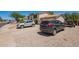 Exterior view of a home showing the driveway and front yard with two parked cars and gravel landscaping at 7259 E Glencove St, Mesa, AZ 85207