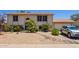 Two-story home with desert landscaping, a basketball hoop, and a beige stucco exterior at 7259 E Glencove St, Mesa, AZ 85207