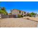 Desert landscaped two-story home featuring a gated driveway and neutral stucco exterior at 7259 E Glencove St, Mesa, AZ 85207