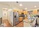 Bright kitchen featuring stainless steel appliances, light wood cabinetry, and granite countertops at 7259 E Glencove St, Mesa, AZ 85207